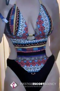 Woman wearing patterned swimsuit.